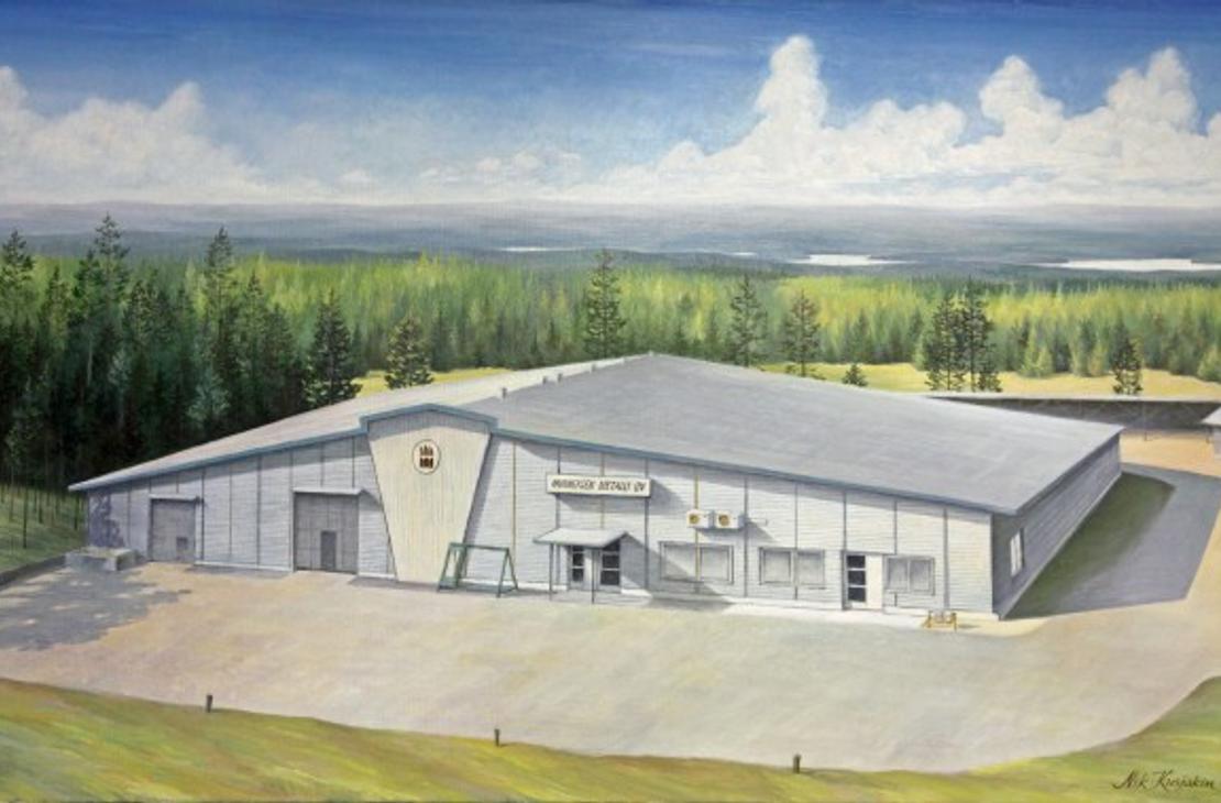 Maalaukselta tai akvarellilta näyttävä kuva Nurmeksen Metalli Oy:n toimitilasta. Rakennus on suuri, harmaansävyinen teollisuus- tai hallirakennus tasakattoineen. Keskellä rakennusta on kulmikas, vaalea koroste, mahdollisesti sisäänkäynti. Rakennuksen edessä on sorapiha, ja sitä ympäröi tiheä, tummanvihreä havumetsä. Taivas on sininen ja pilvinen.